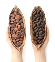 Woman holding cocoa pods with beans on white background, top view