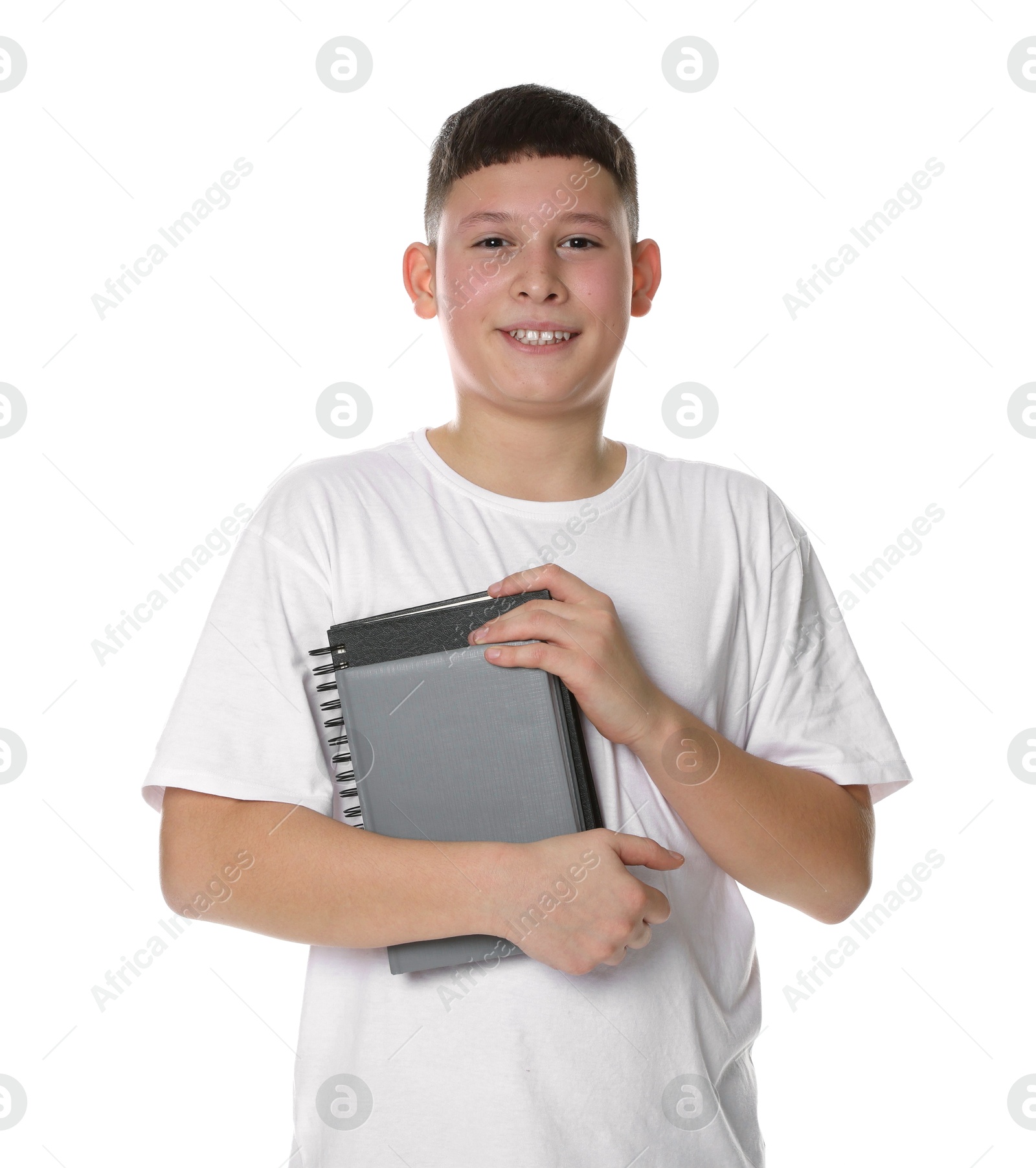 Photo of Portrait of teenage boy with books on white background