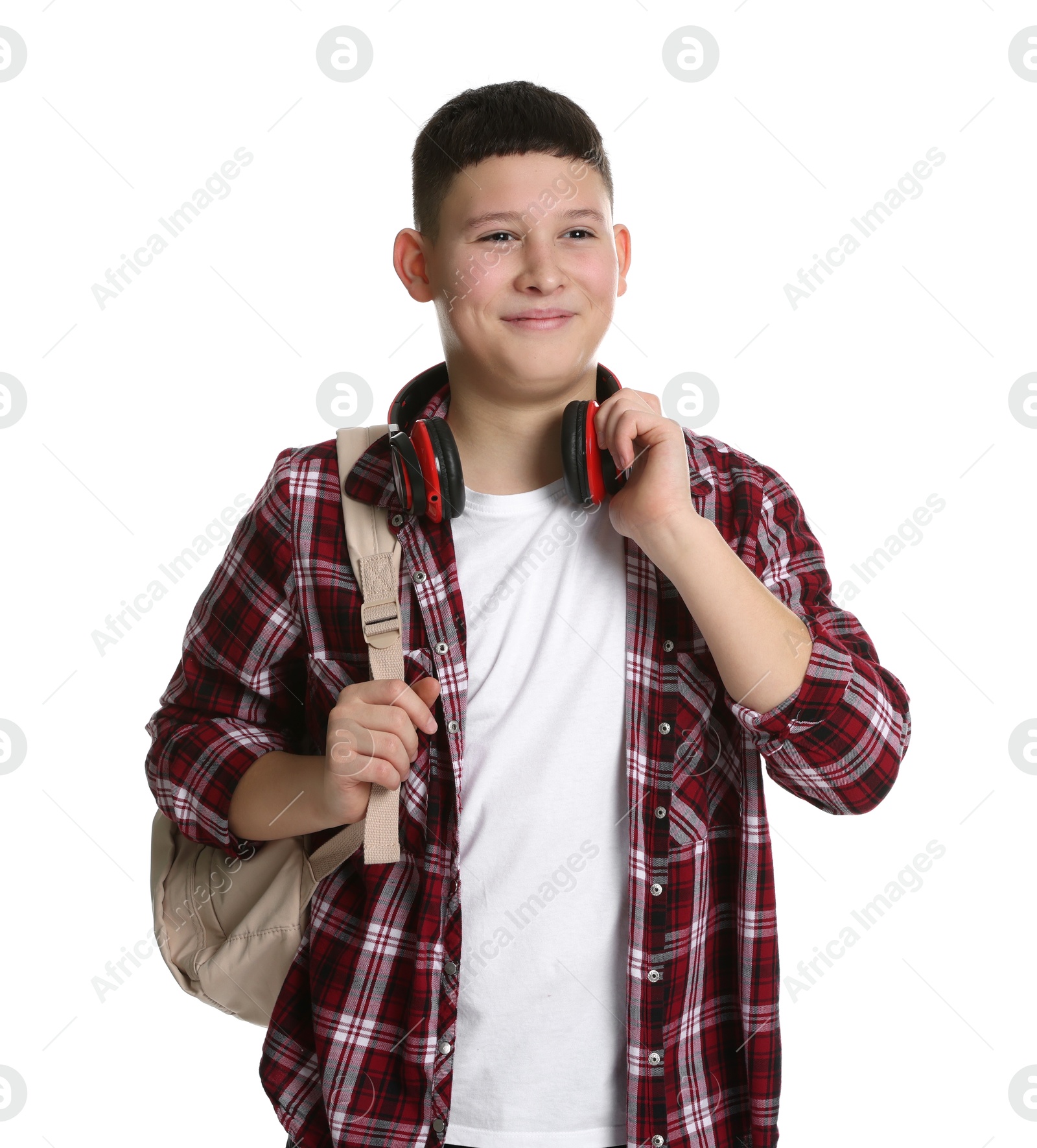 Photo of Portrait of teenage boy with headphones and backpack on white background