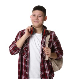 Photo of Portrait of teenage boy with headphones and backpack on white background