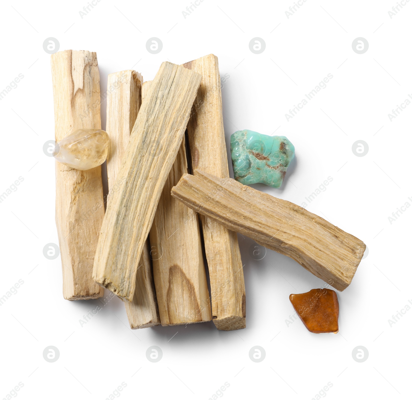 Photo of Palo santo sticks and gemstones isolated on white, top view