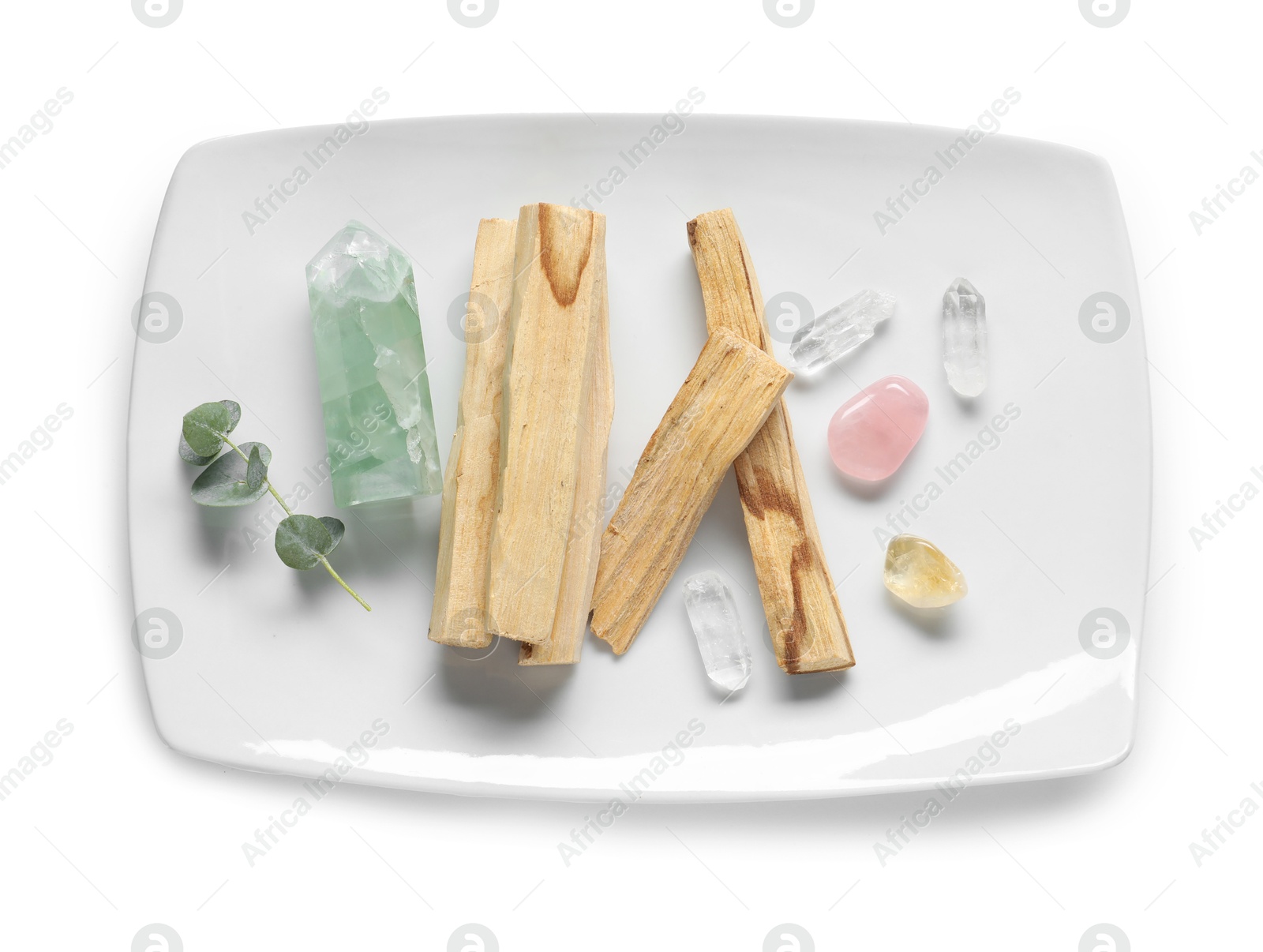 Photo of Palo santo sticks and gemstones isolated on white, top view