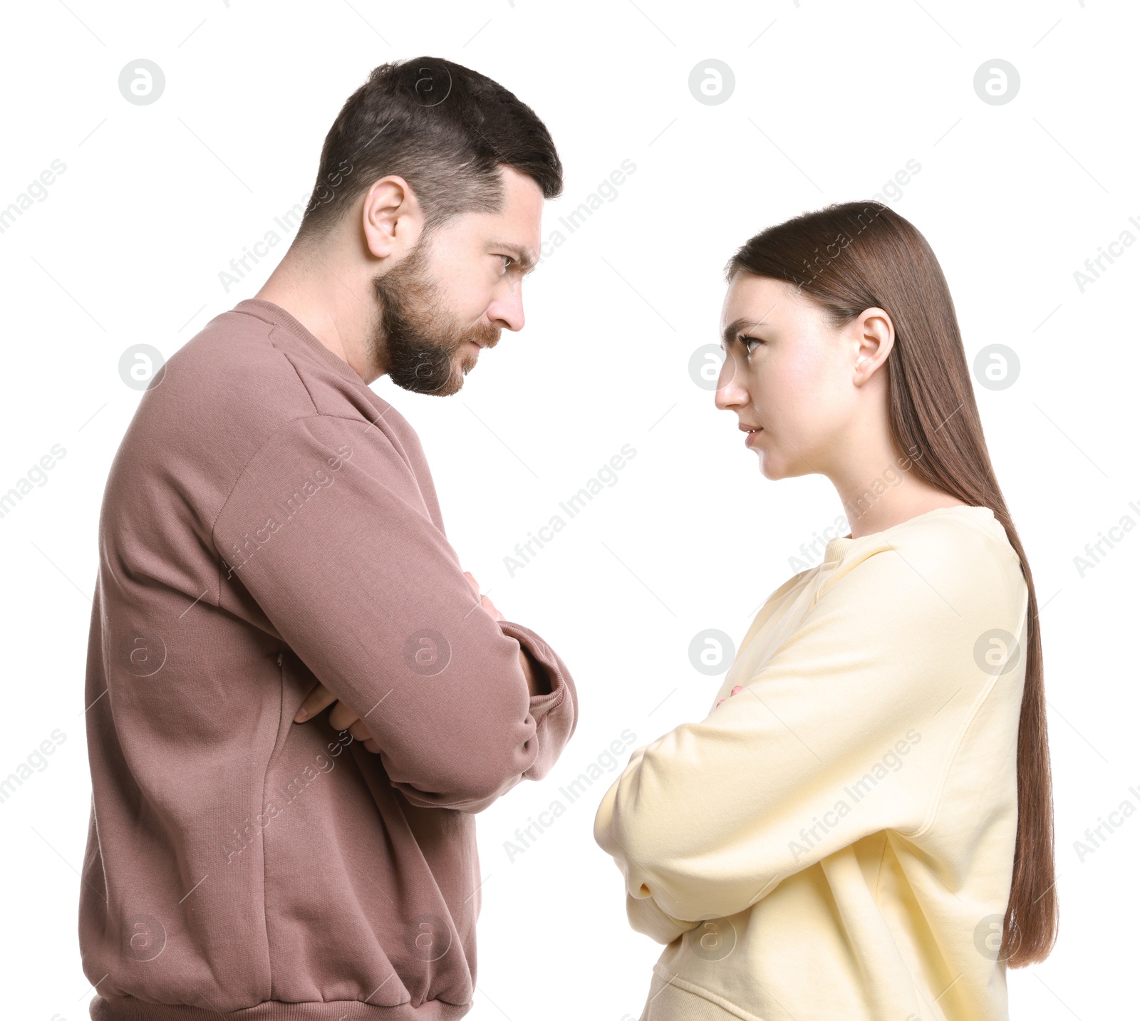 Photo of Resentful couple with crossed arms on white background