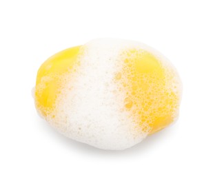 Photo of Yellow soap with foam on white background, top view