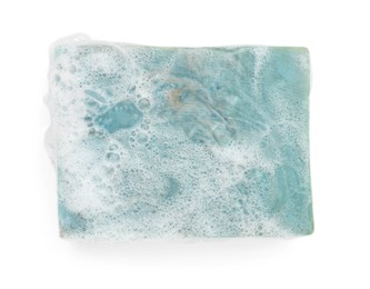 Photo of Blue soap with foam on white background, top view