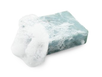 Photo of Bar soap with foam on white background