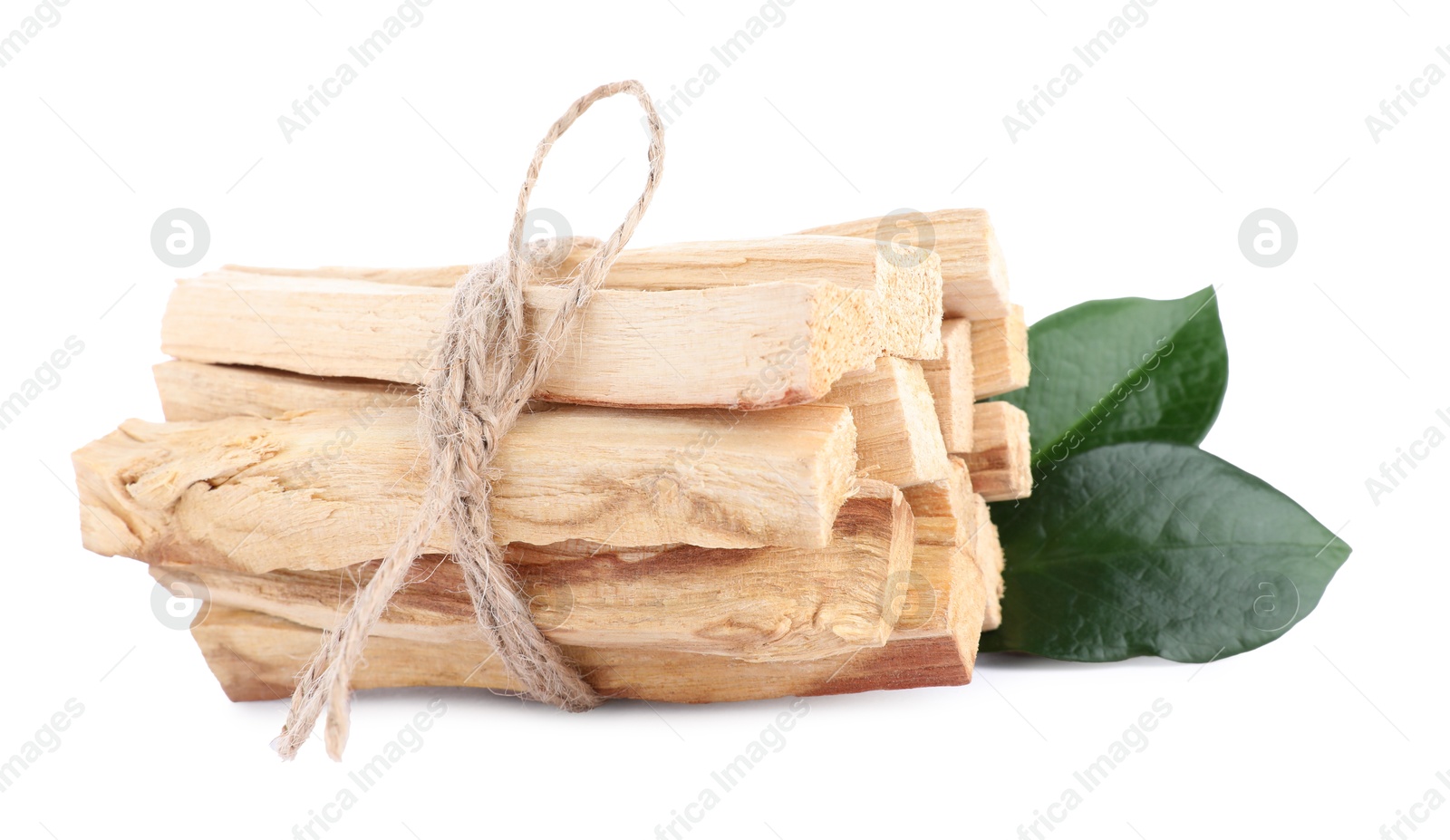 Photo of Bunch of palo santo sticks and green leaves on white background