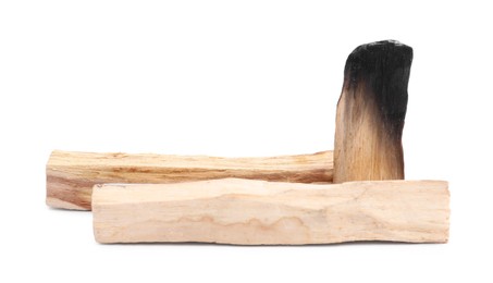 Photo of Whole palo santo sticks and burnt one on white background