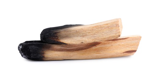 Photo of Burnt palo santo sticks on white background