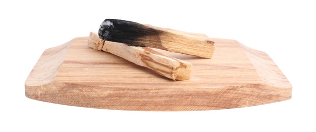 Photo of Whole palo santo stick and burnt one on white background