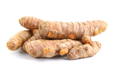 Photo of Pile of fresh turmeric roots isolated on white