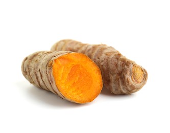 Photo of Whole and cut turmeric roots isolated on white