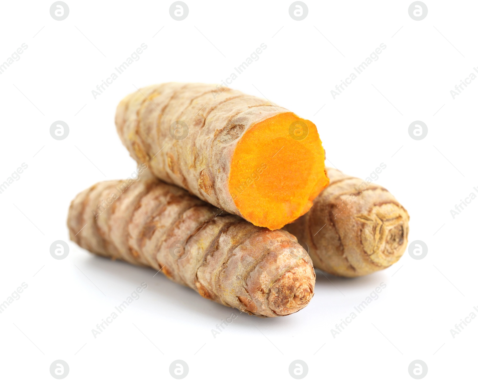 Photo of Whole and cut turmeric roots isolated on white