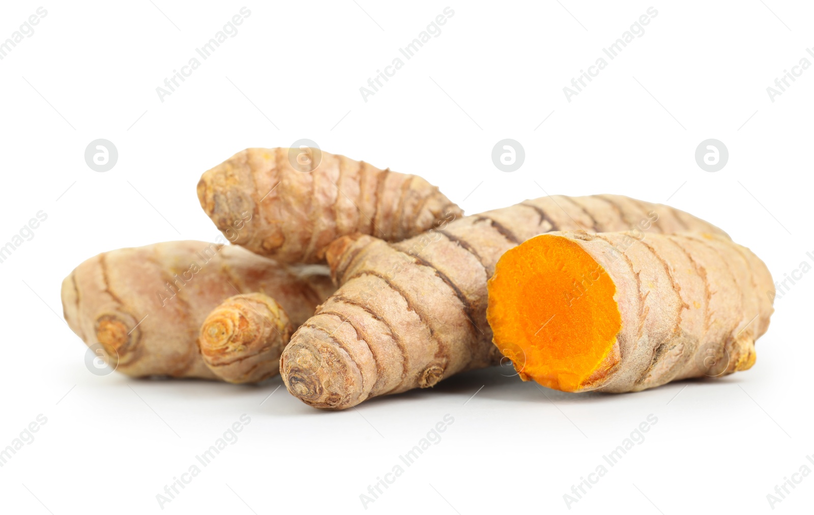 Photo of Whole and cut turmeric roots isolated on white