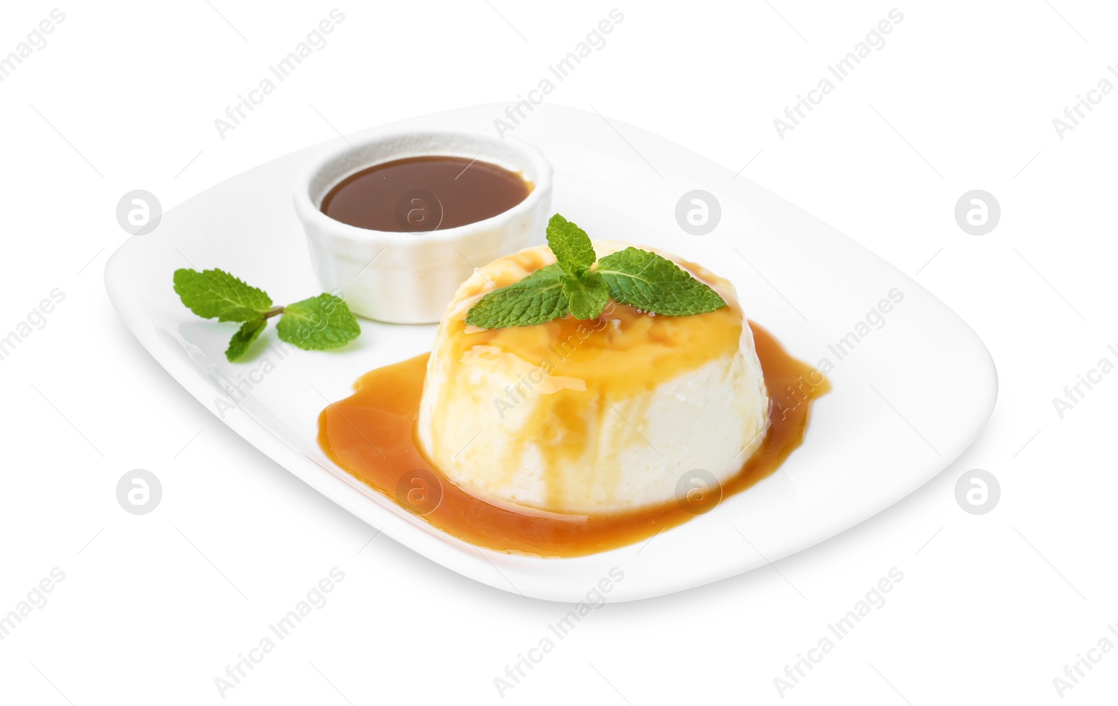 Photo of Tasty pudding with caramel sauce and mint isolated on white