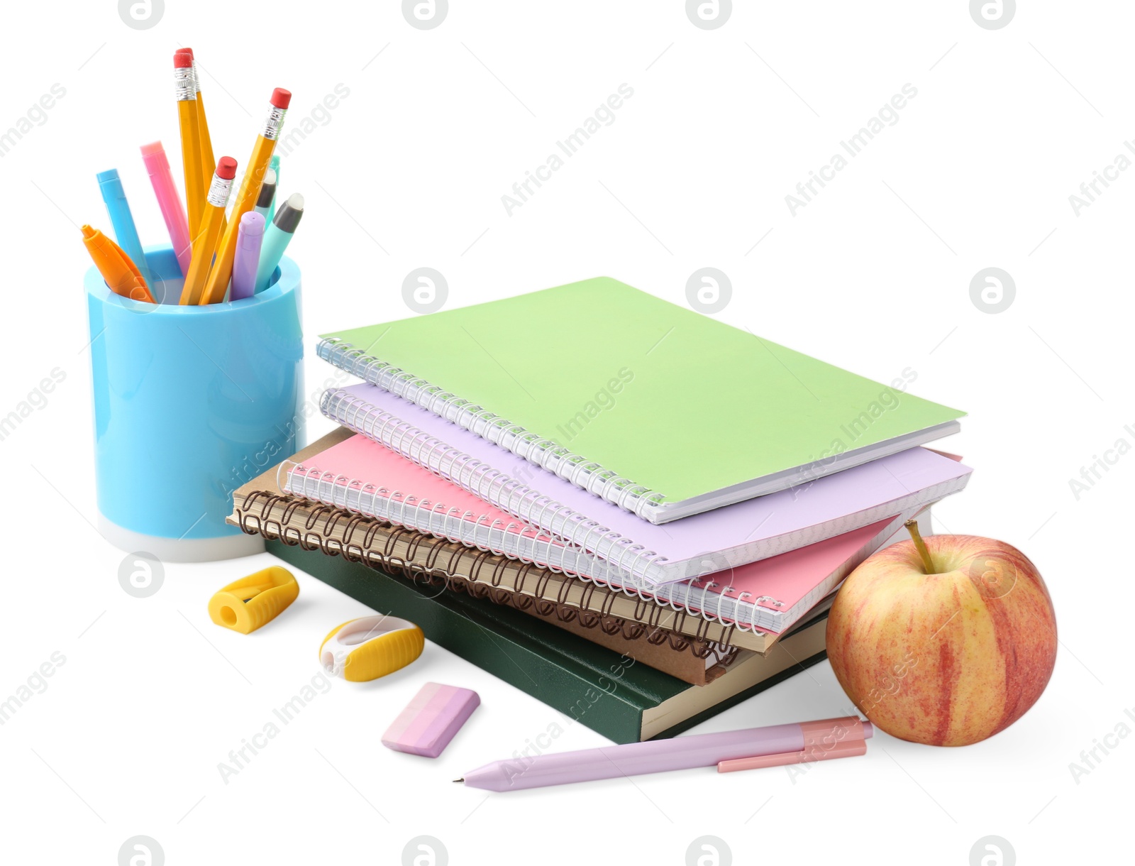 Photo of Doing homework. Notebooks, apple and stationery on white background