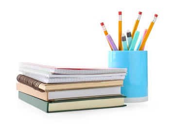 Photo of Stack of notebooks, books and other stationery on white background