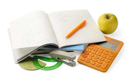 Photo of Doing homework. Notebook with math assignment, apple and stationery isolated on white