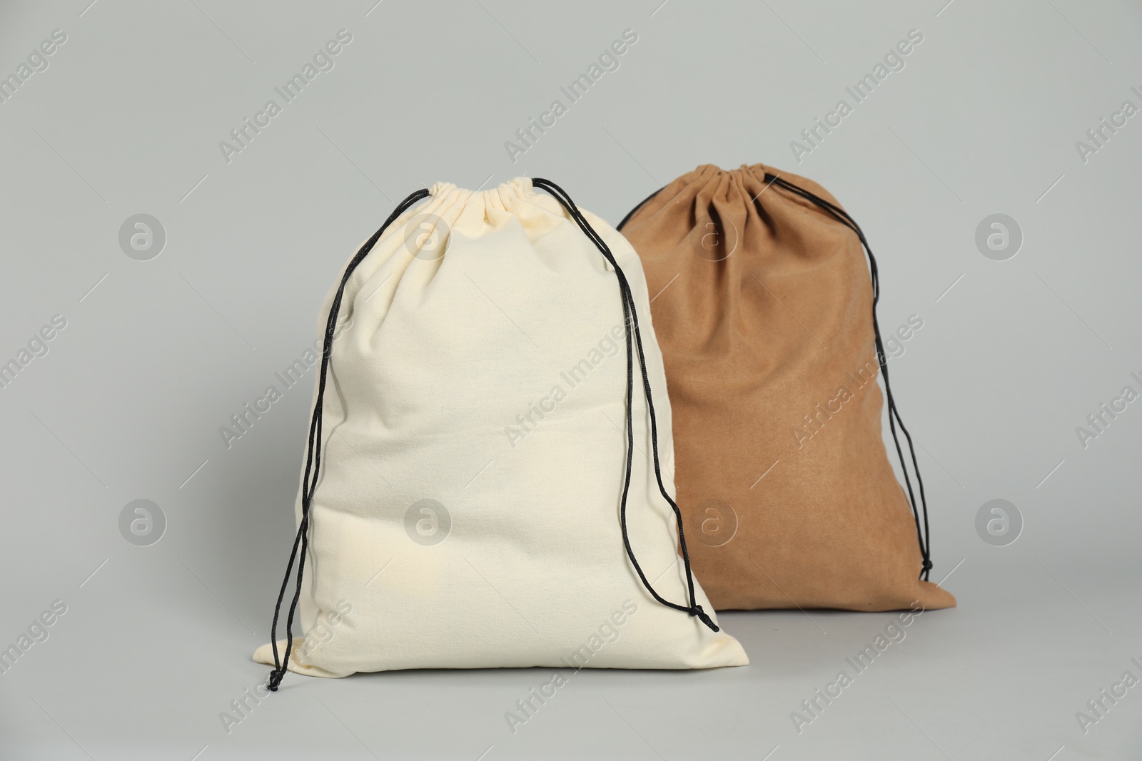 Photo of Two colorful cotton bags on grey background