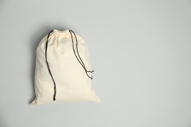 Photo of Cotton bag on grey background, top view. Space for text