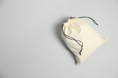 Photo of Cotton bag on grey background, top view. Space for text