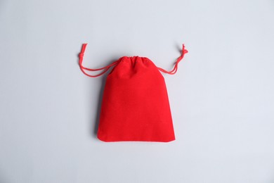 Photo of One red cotton bag on light background, top view