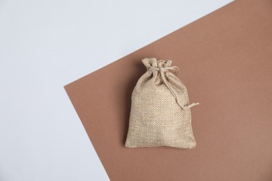 Photo of One burlap bag on color background, top view. Space for text