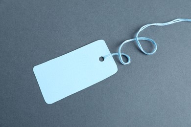 Photo of Blank tag with string on grey background, top view