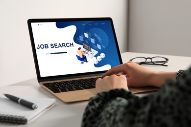 Image of Job search. Woman using employment website on laptop at home, closeup