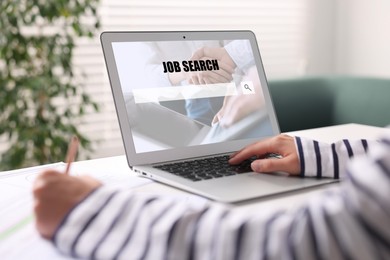 Image of Woman looking for job using employment website on laptop at home, closeup