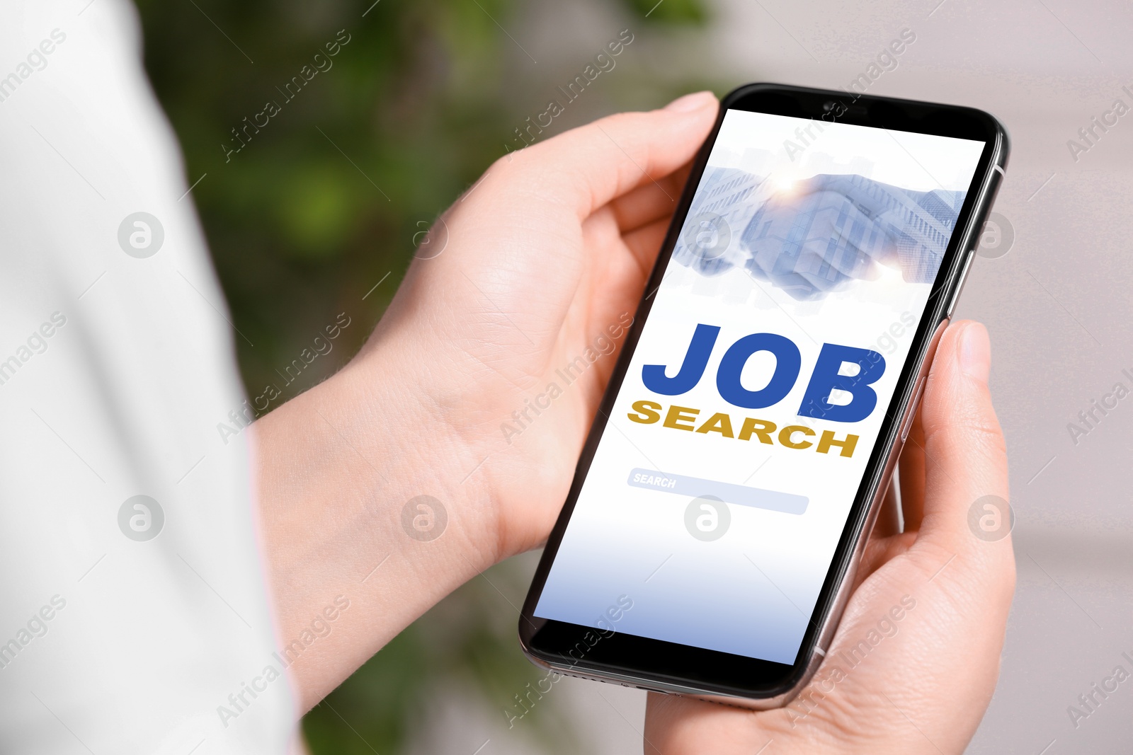 Image of Woman looking for job using employment website on mobile phone at home, closeup