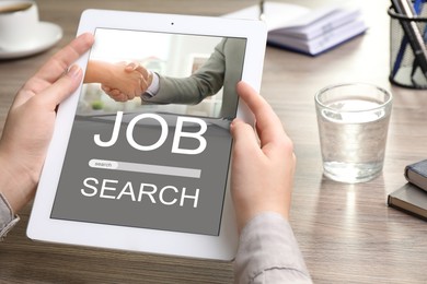 Image of Job search. Woman using employment website on tablet computer at desk, closeup