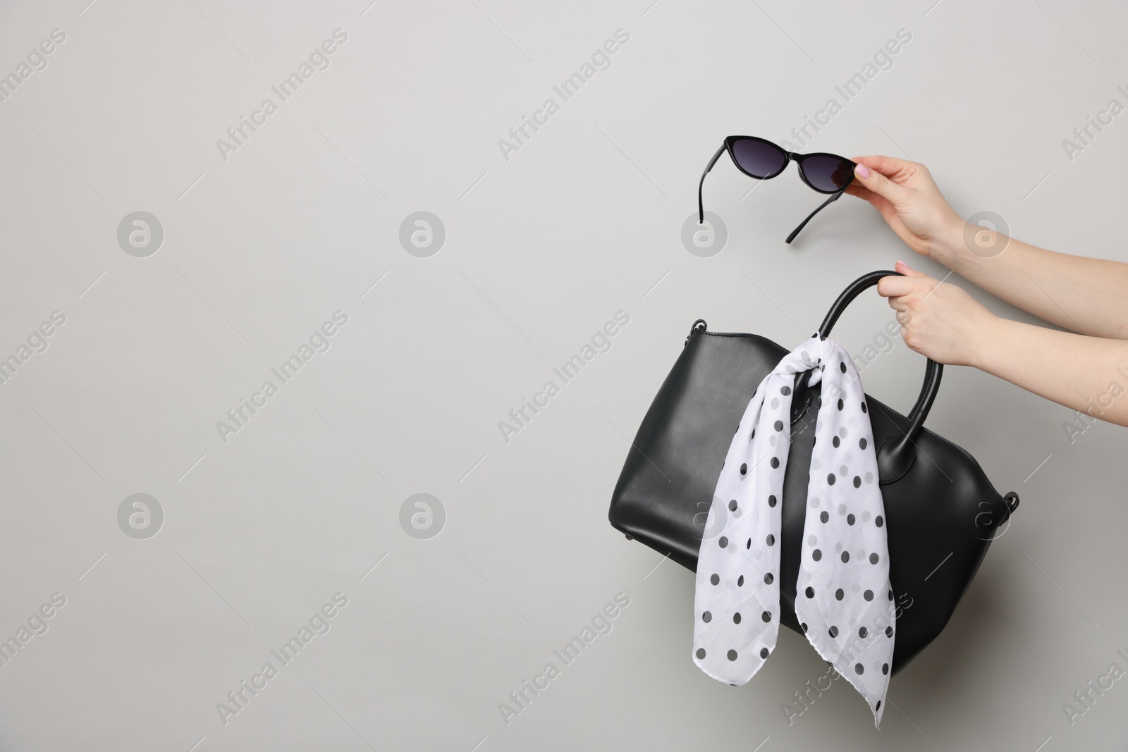 Photo of Women with stylish accessories on light grey background, closeup. Space for text