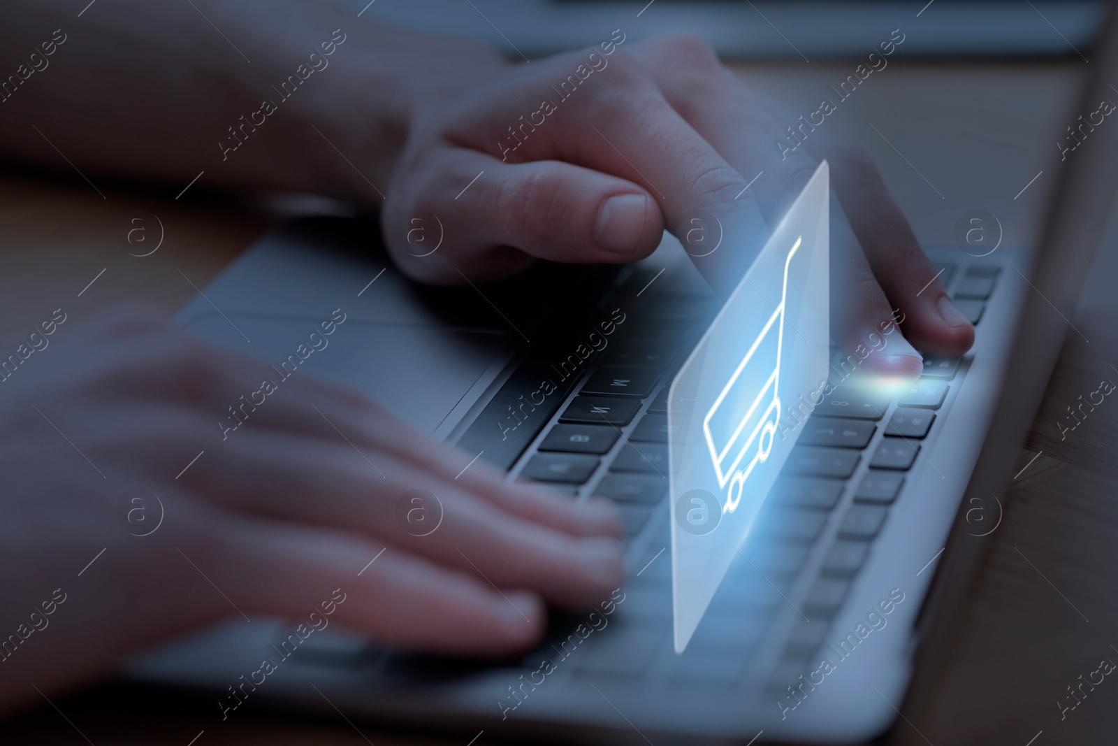 Image of Man shopping online using laptop, closeup. Illustration of shopping cart over device