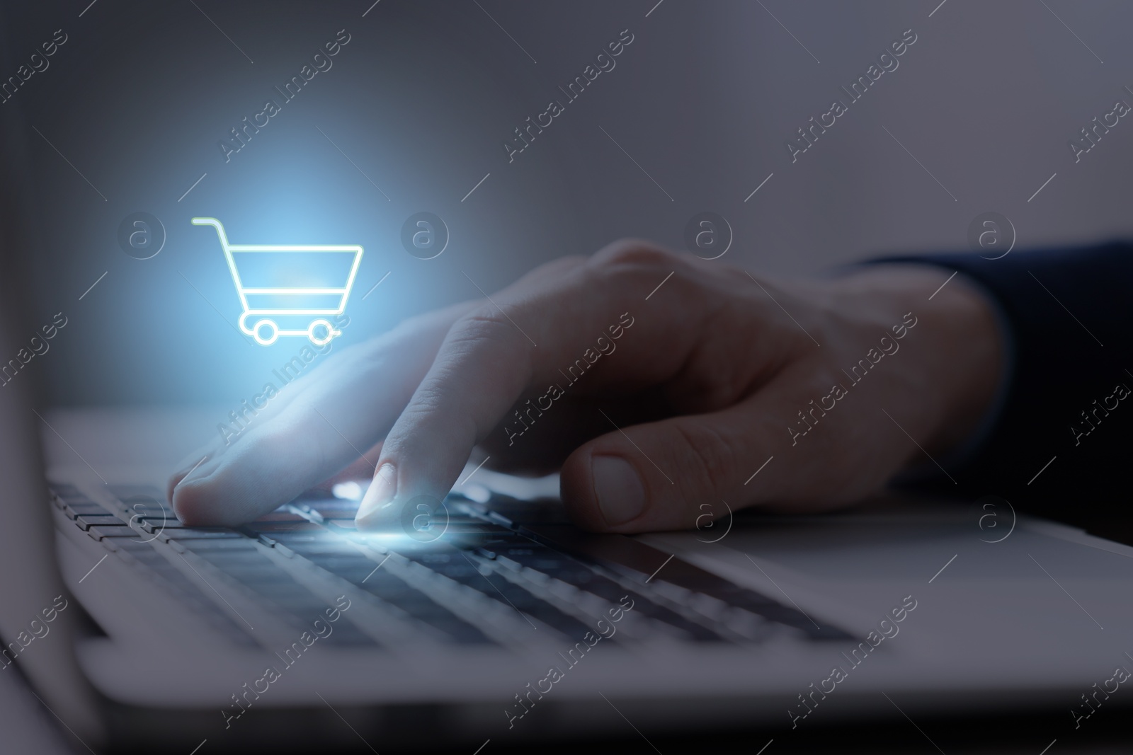 Image of Man shopping online using laptop, closeup. Illustration of shopping cart over device