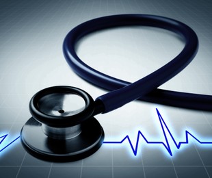 Image of Stethoscope and heartbeat line on color gradient background, closeup. Healthcare concept