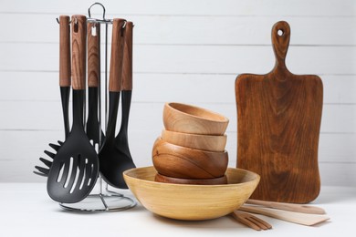 Photo of Dishware and cooking utensils on white table