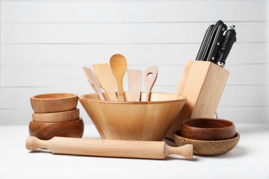 Photo of Dishware and cooking utensils on white table