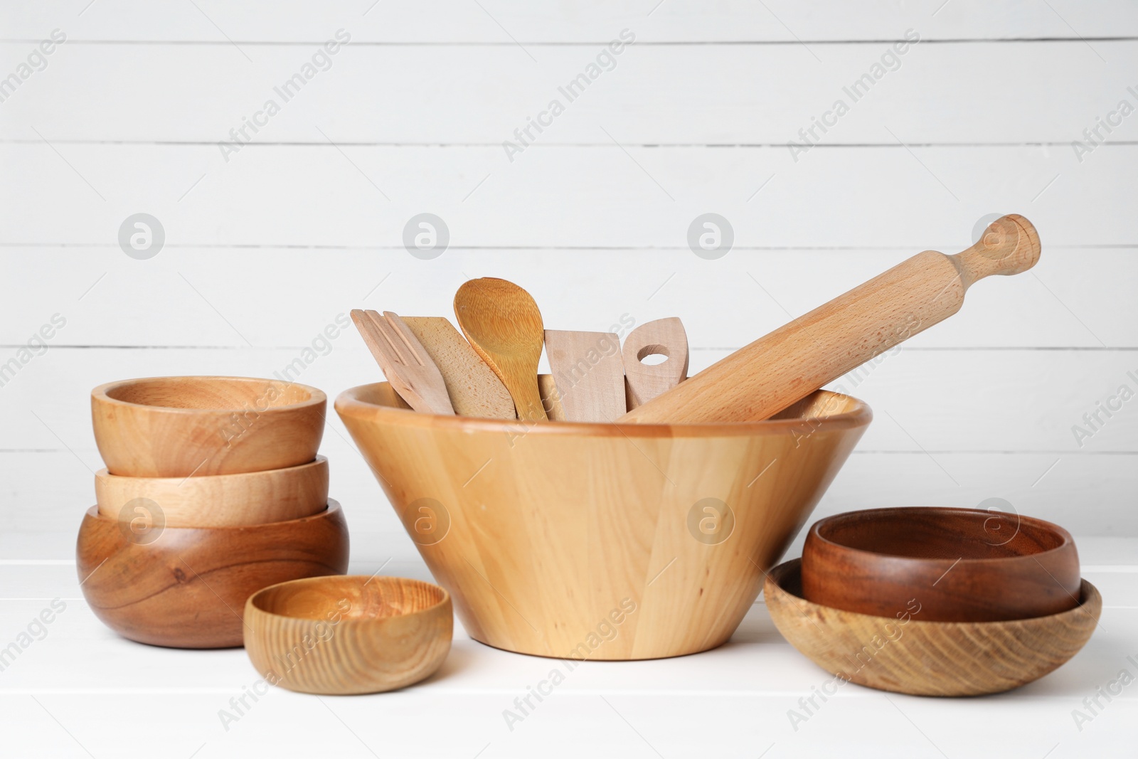 Photo of Dishware and cooking utensils on white table