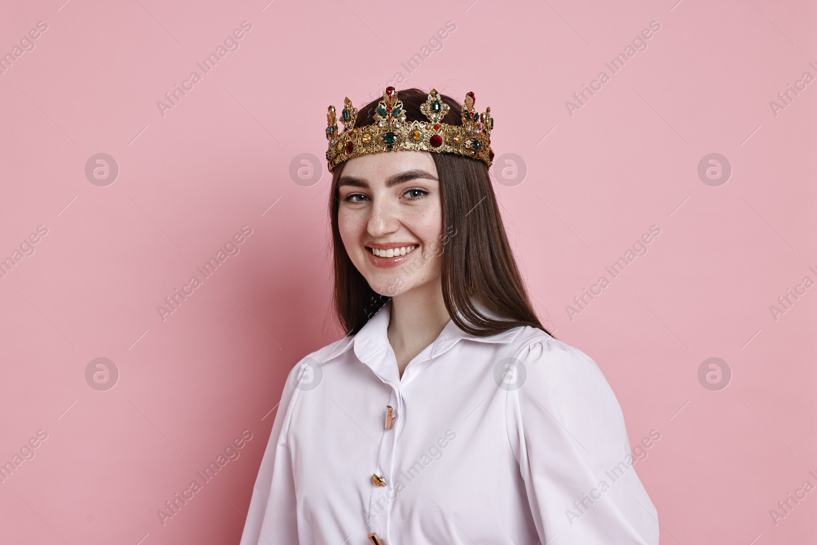 Photo of Happy woman in elegant crown on pink background