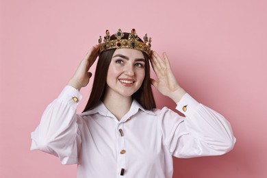 Photo of Happy woman in elegant crown on pink background