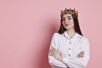 Photo of Woman in elegant crown on pink background. Space for text