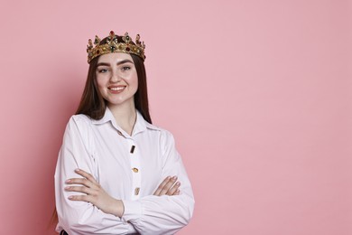 Photo of Happy woman in elegant crown on pink background. Space for text