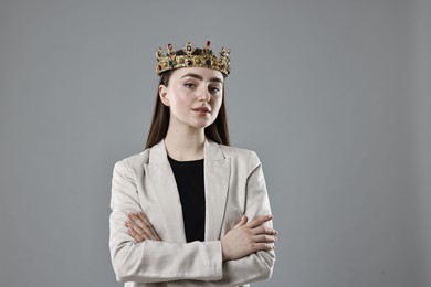 Photo of Businesswoman in elegant crown on grey background