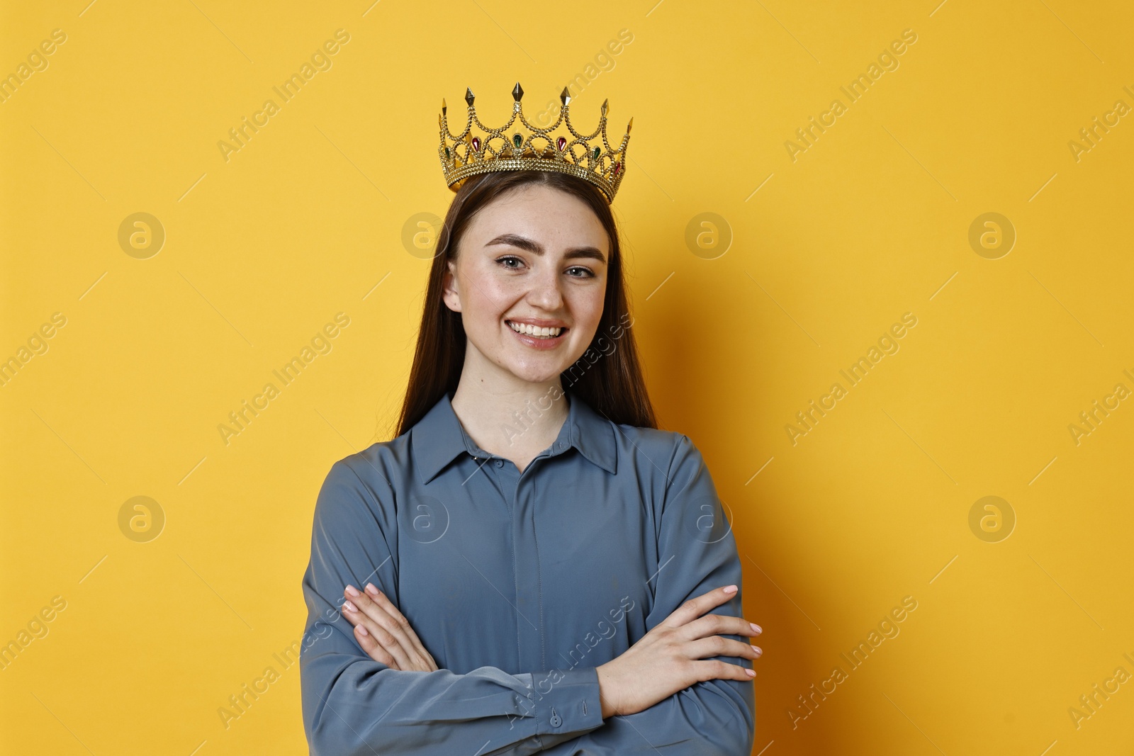 Photo of Happy woman in elegant crown on yellow background