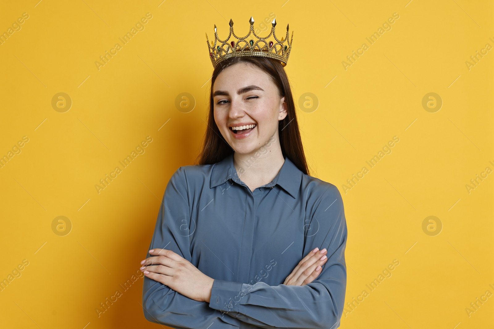 Photo of Happy woman in elegant crown on yellow background