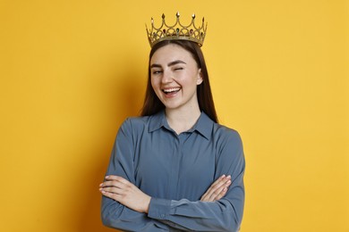 Photo of Happy woman in elegant crown on yellow background