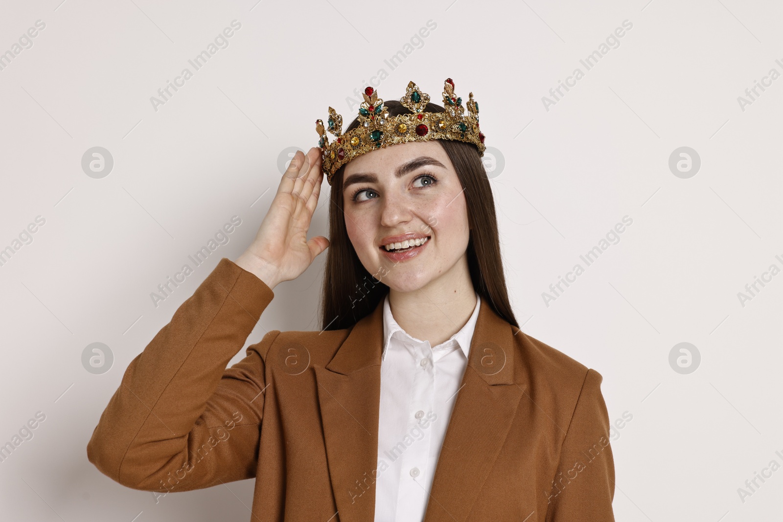 Photo of Happy businesswoman in elegant crown on light background