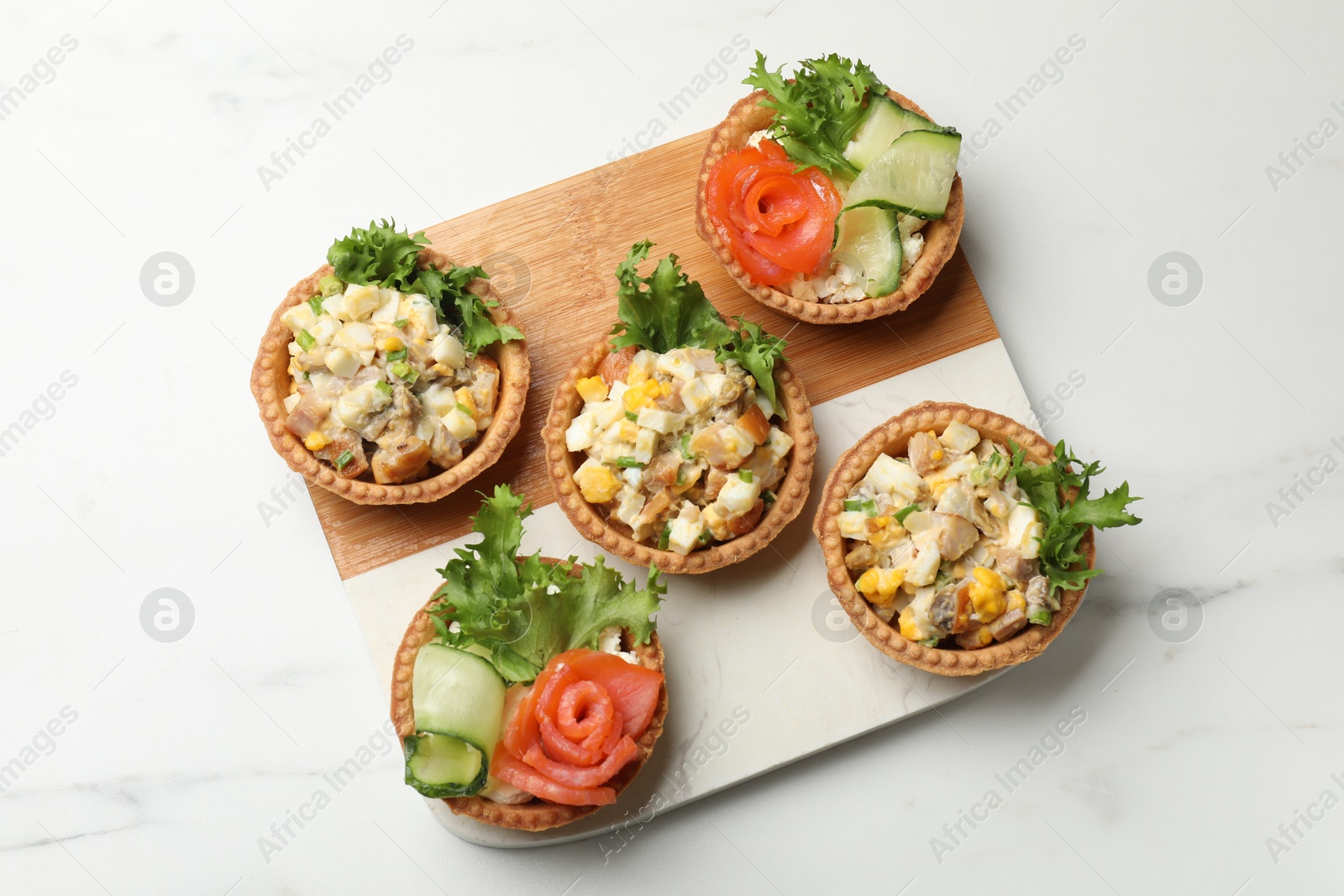 Photo of Tartlets with delicious fillings on white table, top view