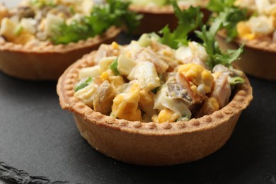 Photo of Tartlets with delicious filling on table, closeup